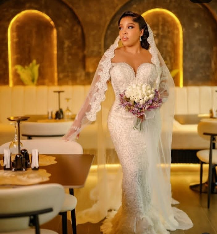 A Gia bride walking to the reception in her lace mermaid gown — Gia Bridals, Port Harcourt