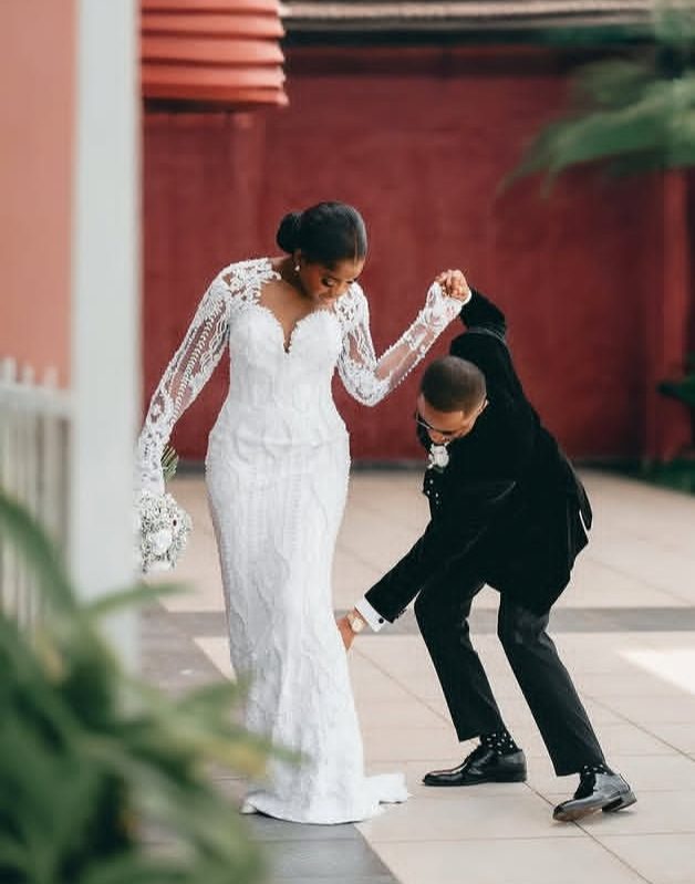 Groom celebrating beside his bride in her lace gown — Gia Bridals, Port Harcourt